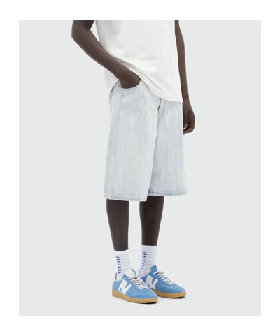 Msgm Bermuda Shorts In Light Denim With A Destroyed Effect In White