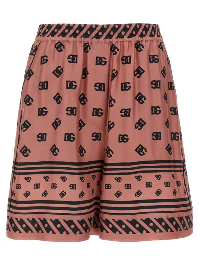 Dolce & Gabbana Pink Bermuda Shorts With Dg Logo Printed All-over In Silk Woman