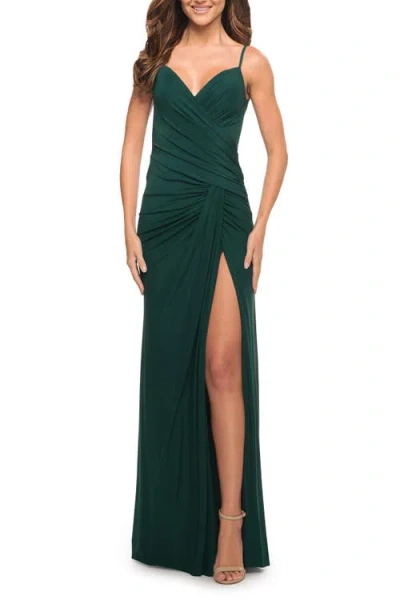 La Femme Net Jersey Long Ruched Gown With Slit And Open Back In Emerald
