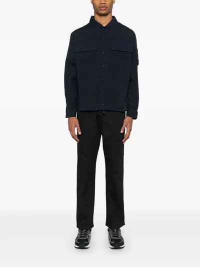 C.p. Company Blue Jacket With Classic Collar And Logo Patch On The Sleeve In Blue