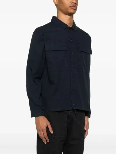 C.p. Company Blue Jacket With Classic Collar And Logo Patch On The Sleeve In Blue