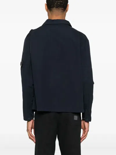 C.p. Company Blue Jacket With Classic Collar And Logo Patch On The Sleeve In Blue