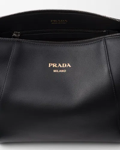 Prada Logo Print Leather Messenger Bag In Black