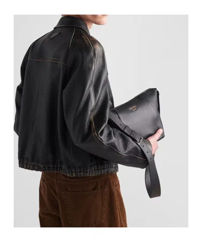 Prada Logo Print Leather Messenger Bag In Black