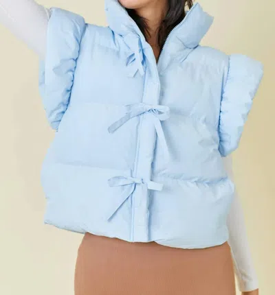 Main Strip Ruffle Puffer Vest With Bow Tie Detail In Light Blue In Blue