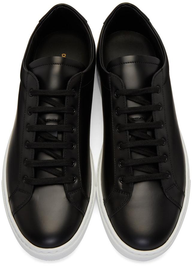 black leather sneaker with white sole