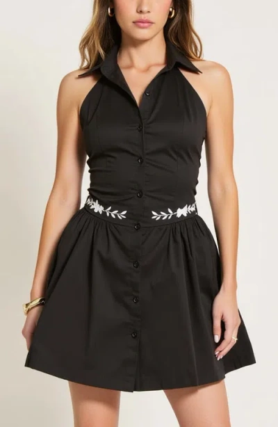 Modenaire Embroidered Waist Button-front Halter Mini Dress With Smocked Open Back In Black