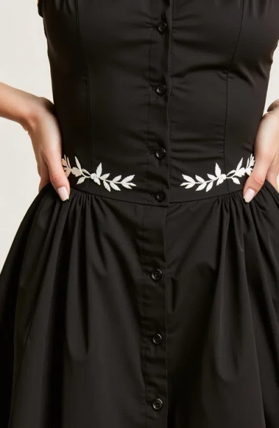 Modenaire Embroidered Waist Button-front Halter Mini Dress With Smocked Open Back In Black