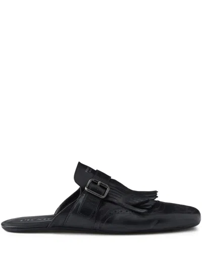 Prada Shuffle Antiqued Leather Mules With Buckled Strap And Fringe In Black