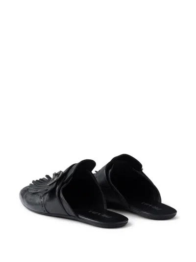 Prada Shuffle Antiqued Leather Mules With Buckled Strap And Fringe In Black