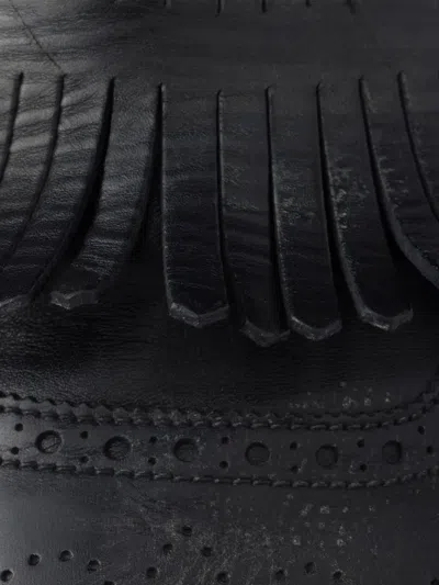 Prada Shuffle Antiqued Leather Mules With Buckled Strap And Fringe In Black