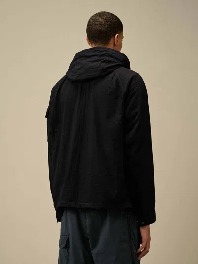 C.p. Company Blue Jacket With Explorer Hood And Adjustable Drawstring Waist In Tech Fabric Man In Black