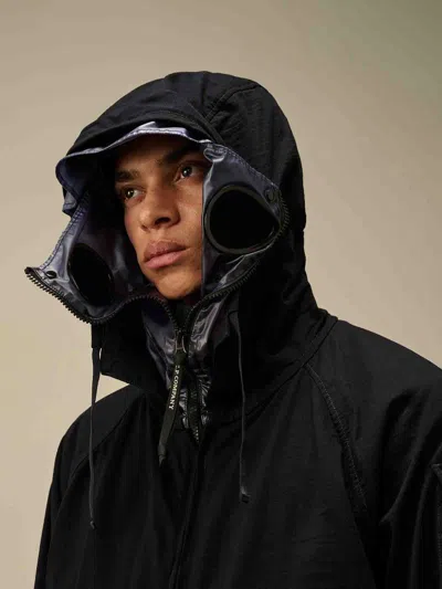 C.p. Company Blue Jacket With Explorer Hood And Adjustable Drawstring Waist In Tech Fabric Man In Black