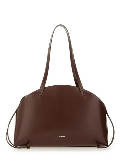 Jil Sander 'curve Medium' Brown Shoulder Bag With Embossed Logo On The Front And Curved Design In Brown