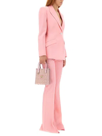 Versace Pink Flare Pants With Tonal Logo Lettering In Wool Woman In Pink