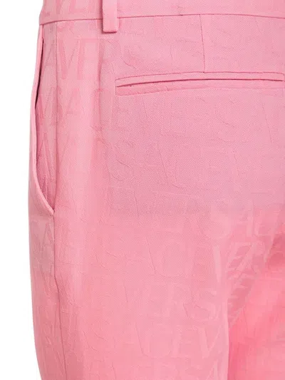 Versace Pink Flare Pants With Tonal Logo Lettering In Wool Woman In Pink