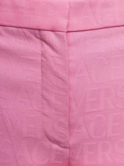 Versace Pink Flare Pants With Tonal Logo Lettering In Wool Woman In Pink