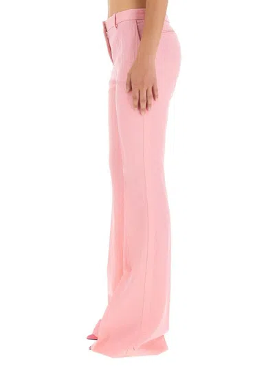 Versace Pink Flare Pants With Tonal Logo Lettering In Wool Woman In Pink