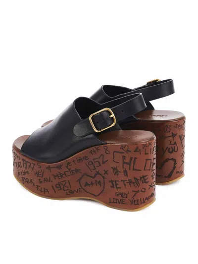 Chloé Maxime Black Wedge With Engraved Written Decorations And Logo Buckle In Leather Woman In Black