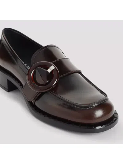 Prada Polished Brown Flat Shoes With Decorative Buckle In Black