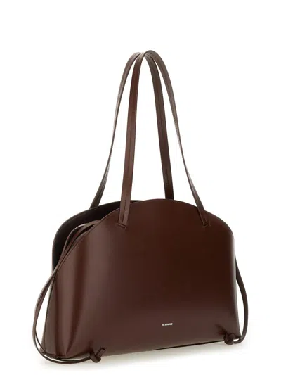 Jil Sander 'curve Medium' Brown Shoulder Bag With Embossed Logo On The Front And Curved Design