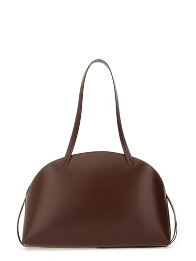 Jil Sander 'curve Medium' Brown Shoulder Bag With Embossed Logo On The Front And Curved Design