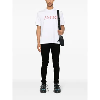 Amiri Slim Fit Distressed Trousers With Rivet Detailing