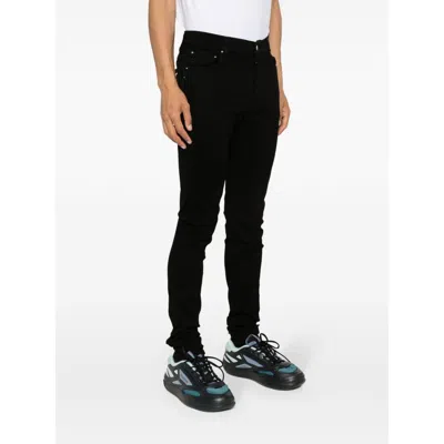 Amiri Slim Fit Distressed Trousers With Rivet Detailing