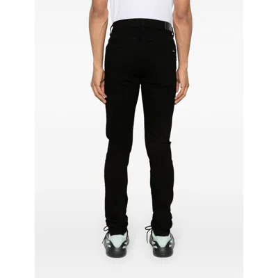 Amiri Slim Fit Distressed Trousers With Rivet Detailing