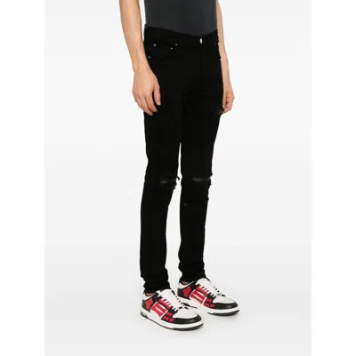 Amiri Slim Fit Distressed Trousers With Rivet Detailing
