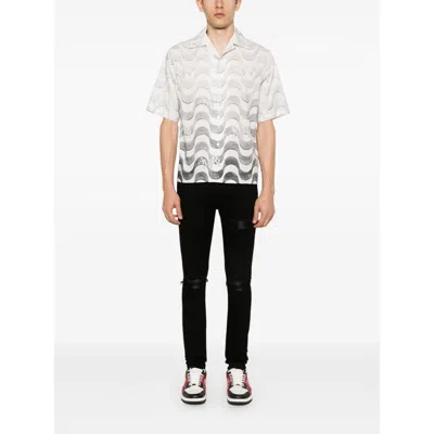 Amiri Slim Fit Distressed Trousers With Rivet Detailing