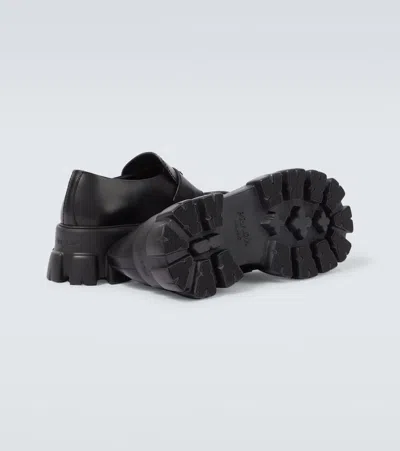 Prada Tread Sole Triangular Logo Plaque Leather Penny Loafers In Black