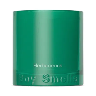Boy Smells Herbaceous Candle In Green