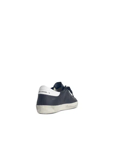 Golden Goose 'super-star' Black Low Top Sneakers With Logo Patch And Suede Details In Leather Man In Black