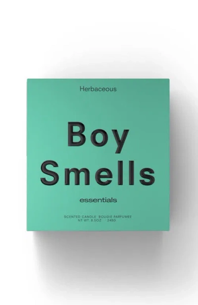 Boy Smells Herbaceous Candle In Green