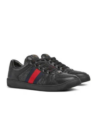 Gucci Gg Embossed Leather Low-top Sneakers In Black