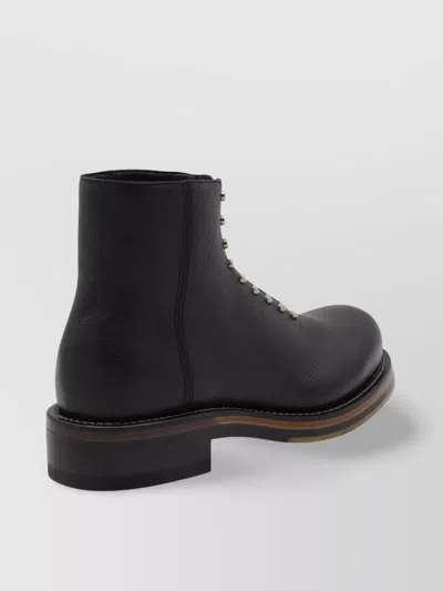 Alexander Mcqueen Chunky Sole Round Toe Studded Ankle Boots In Black