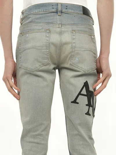 Amiri Men's Staggered Logo Skinny Jeans In Blue