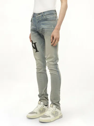 Amiri Men's Staggered Logo Skinny Jeans In Blue