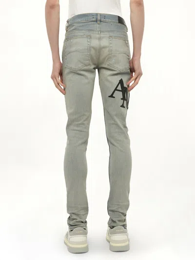 Amiri Men's Staggered Logo Skinny Jeans In Blue