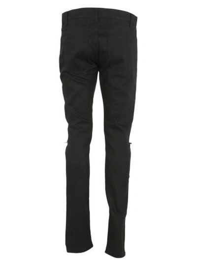 Shop Saint Laurent Busted Knee Slim Jeans In Black
