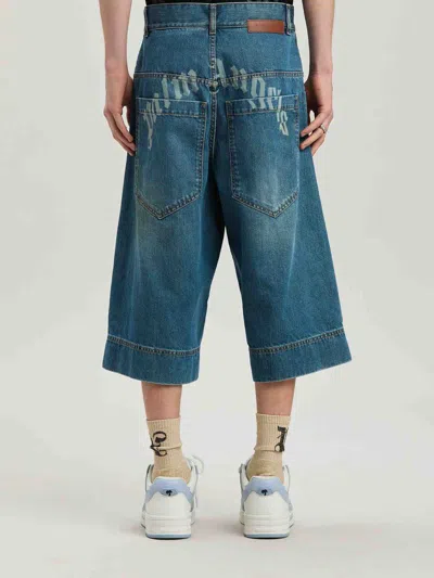 Palm Angels Lasered Curved Logo Denim Skater Bermuda In Blue