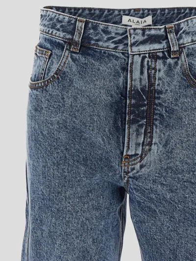 Alaïa Twisted Stonewashed Denim Jeans In Blue