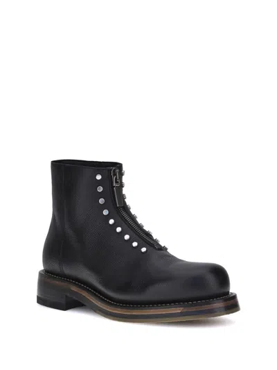 Alexander Mcqueen Chunky Sole Round Toe Studded Ankle Boots In Black