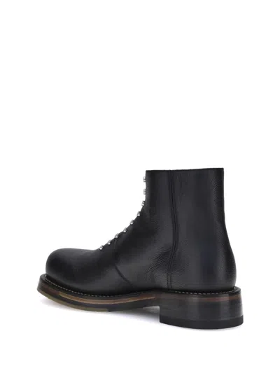 Alexander Mcqueen Chunky Sole Round Toe Studded Ankle Boots In Black