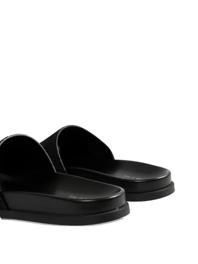 Gucci Men Leather Slides With All-over Gg Motif In Black