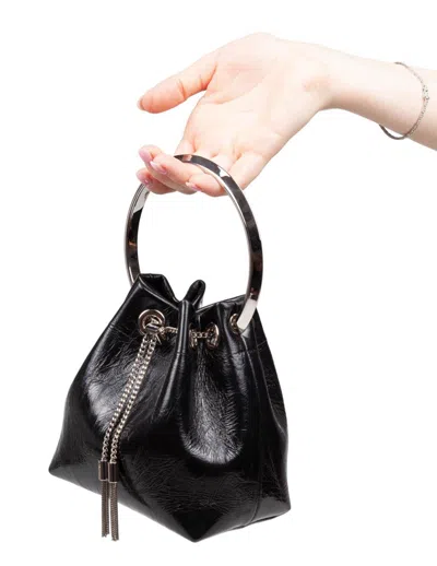 Jimmy Choo Eyelet Chain Bucket Bag With Metallic Handle In Black