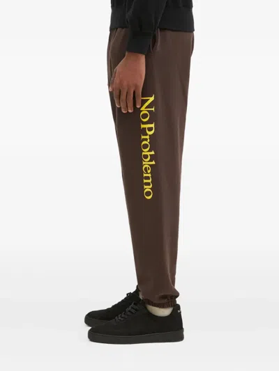 Aries Slogan-print Sweatpants In Brown