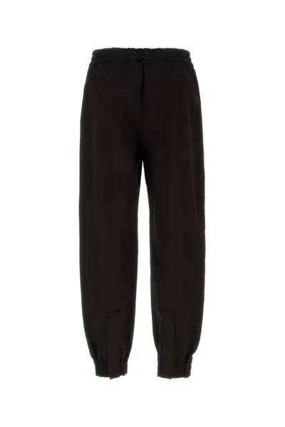 Alexander Mcqueen Men Printed Trousers In Black