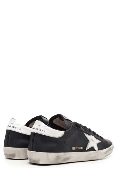 Golden Goose 'super-star' Black Low Top Sneakers With Logo Patch And Suede Details In Leather Man In Black
